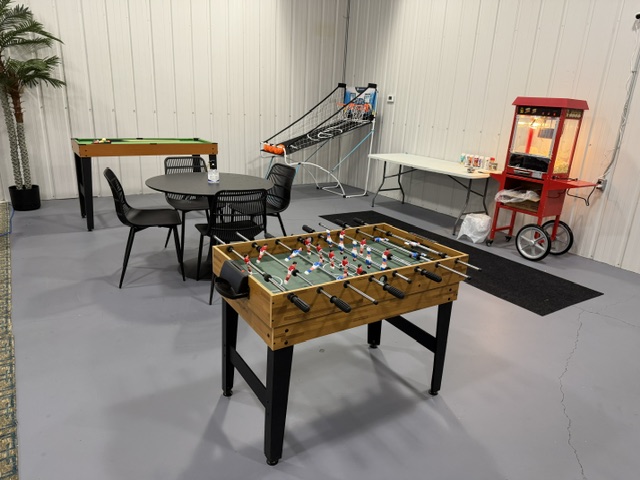Sharalife student lounge with foosball table, games, seating, and popcorn machine