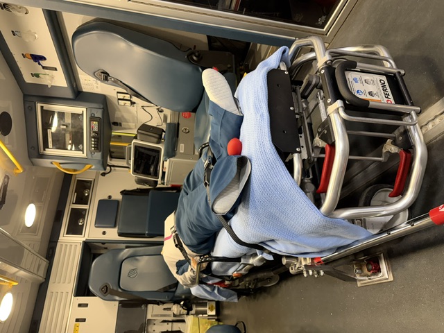 Close view of ambulance training stretcher, simulation mannequin, and onboard equipment